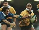George Gregan runs with the ball against France