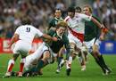 Francois Steyn is tackled hard by an English defender