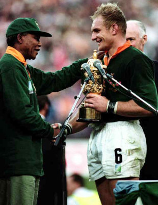 South African president Nelson Mandela presents Springbok captain Francois Pienaar with the Webb Ellis Cup, South Africa v New Zealand, World Cup final, Ellis Park, June 24 1995.