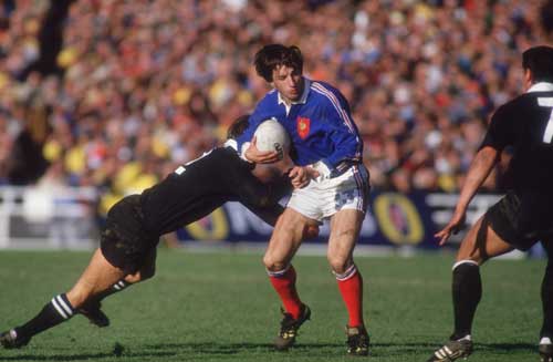 Philippe Sella tries to dance through the All Black defence