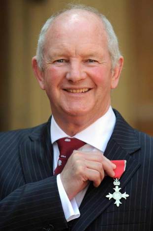 Former England Rugby Union Head Coach Brian Ashton poses for photographs after collecting his Member of the British Empire (MBE) from Britain's Queen Elizabeth II at Buckingham Palace, in London, on May 7, 2008.