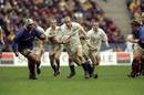 Lawrence Dallaglio charges at the French defence.