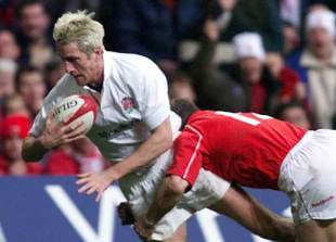 England centre Will Greenwood holds off a tackle to score one of his hat-trick of tries against Wales, Wales v England, Six Nations, Millennium Stadium, February 3 2001.