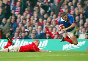 France centre Tony Marsh goes airborne to score despite the tackle of Martyn Williams, Wales v France, Six Nations, Millennium Stadium, February 16 2002.