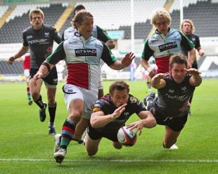 Tommy Bowe (centre) of the Opspreys dives over to score the last minute match winning try during the EDF Energy Cup match between Ospreys and Harlequins at the Liberty Stadium in Swansea, Wales on October 5, 2008 .