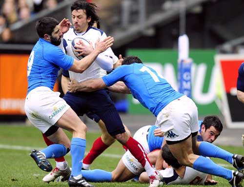 France fullback Clement Poitrenaud is held up by the Italian defence