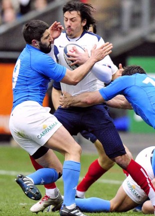 France's Clement Poitrenaud is wrapped up by the Italy defence, France v Italy, Six Nations, Stade de France, March 14, 2010