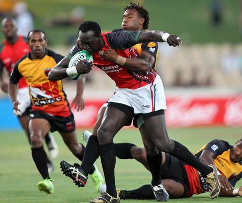 Kenya's Humphrey Kayange is tackled by the Papua New Guinea defence