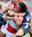 Tonga's Siaosi Iongi is wrapped up by the Scotland defence