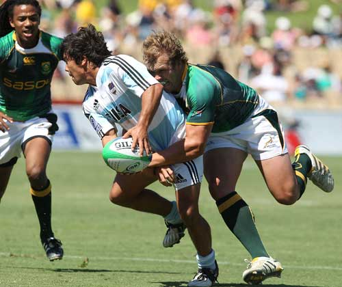 Argentina's Tomas Passerotti is tackled by South Africa's Frankie Horne