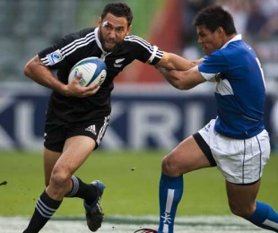 Chinese Taipei's Wang Kuo-Feng is handed off by New Zealand's Zar Lawrence during their match at the Hong  Kong Sevens, Hong Kong, China, March 26, 2010