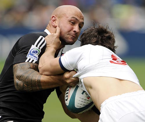 New Zealand's DJ Forbes shrugs off a tackle from France's Romain Raine