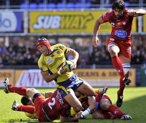 Clermont's Alexandre Audebert looks for the offload under pressure from three Montpellier defenders