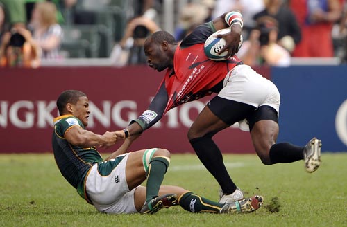 Kenya's Lavin Asego is dragged to the floor by South Africa's Ryno Benjamin