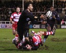 Newcastle centre Tane Tu'ipulotu offloads for the opening try