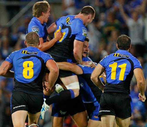 The Western Force players mob David Hill after his last-gasp drop goal