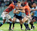 The Waratahs' Lachie Turner is wrapped up by the Cheetahs' defence