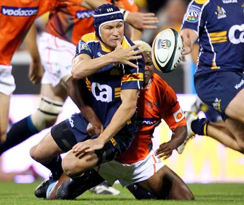 The Brumbies' Matt Giteau off loads the ball in the tackle