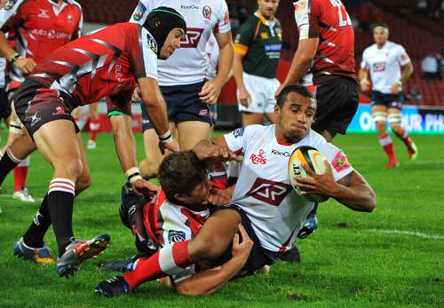 The Reds' Will Genia is hauled down by the Lions' defence