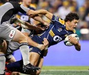 The Brumbies' Adam Ashley-Cooper stretches the Hurricanes' defence