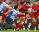 The Reds' Digby Ioane hands off the Bulls' Pierre Spies