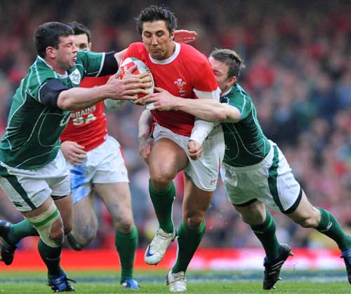 Wales' Gavin Henson stretches the Ireland defence