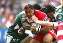 Gloucester wing Lesley Vainikolo is tackled by Seilala Mapusua