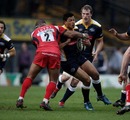Leeds centre Luther Burrell is stopped in his tracks by Aleki Lutui