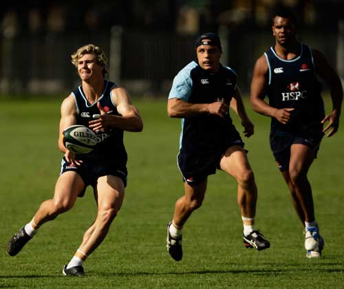 Waratahs centre Berrick Barnes directs the action during training