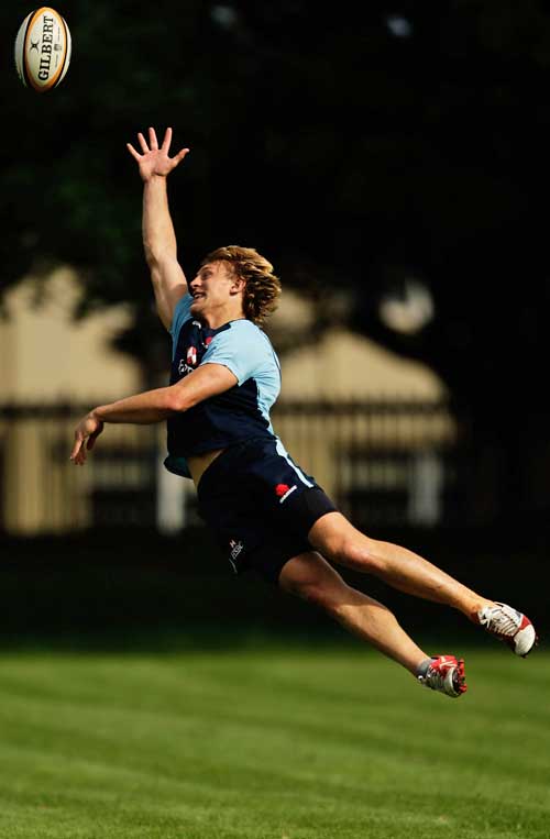 The Waratahs' Lachie Turner stretches for the ball