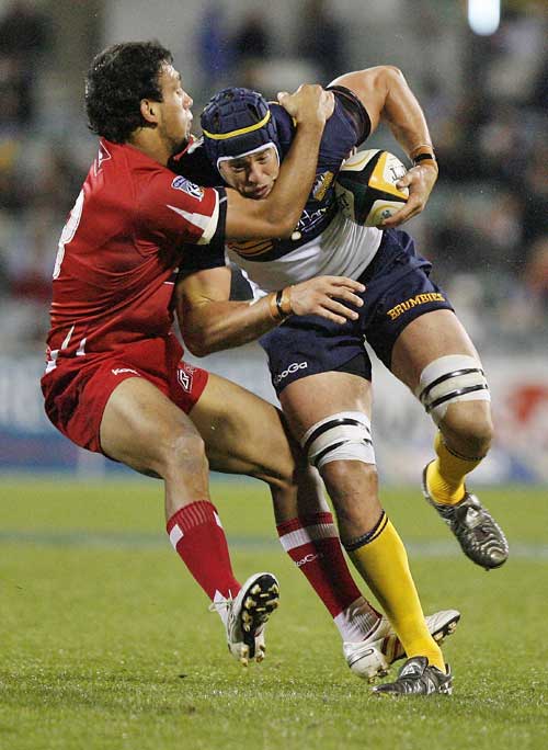 The Reds' Will Chambers tackles the Brumbies' Mark Chisholm