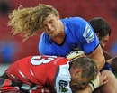 The Western Force's Nick Cummins is tackled by the Lions' Deon van Rensburg
