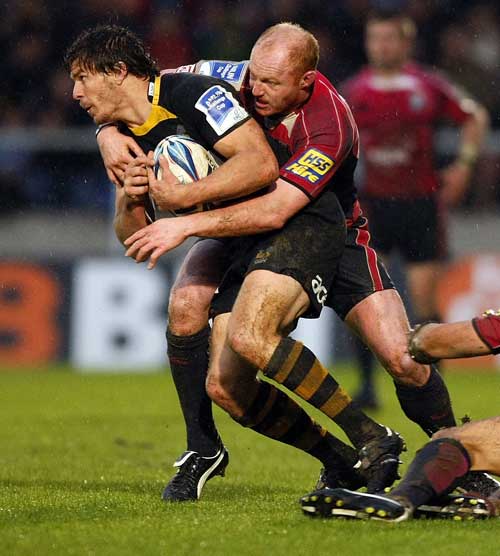 Wasps' Ben Jacobs is wrapped up by the Blues' Martyn Williams