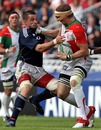 Biarritz's Imanol Harinordoquy fends off Munster's Alan Quinlan