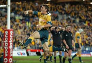 Mat Rogers of Australia celebrates scoring a try in the closing minutes of the Bledisloe Cup clash with New Zealand to seal a 16-14 win for the Wallabies, Australia v New Zealand, Tri Nations, Telstra Stadium, August 3 2002