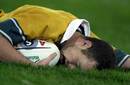Stirling Mortlock lies exhausted after scoring