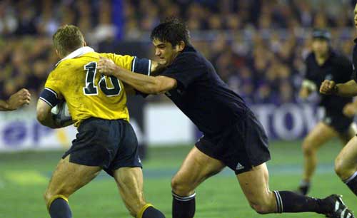 Taine Randell tackles Tim Horan