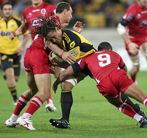 The Hurricanes' Rodney So'oialo is confronted by the Reds' defence