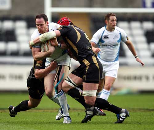 Glasgow centre Graeme Morrison is wrapped up by the Ospreys' defence