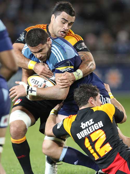 Blues lock Kurtis Haiu is stopped by Chiefs centre Phil Burleigh