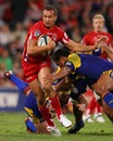 Reds fly-half Quade Cooper stretches the Highlanders' defence