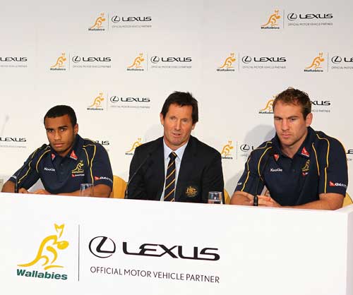 Australia coach Robbie Deans sits and players Will Genia and Rocky Elsom