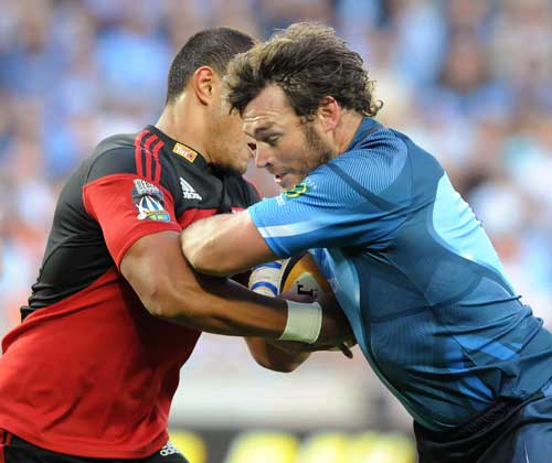 The Bulls' Danie Rossouw is tackled by Crusaders' Robbie Fruean