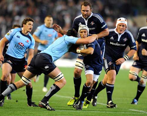 Stormers wing Gio Aplon is collared by the Waratahs' defence