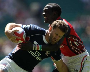 Kevin Swiryn of the USA is collared by a Kenyan tackler
