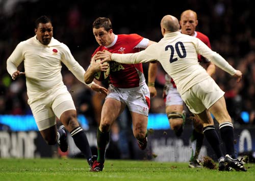 Wales wing Shane Williams bursts through the England defence