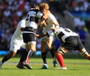 England's David Strettle is shackled by the Barbarians defence