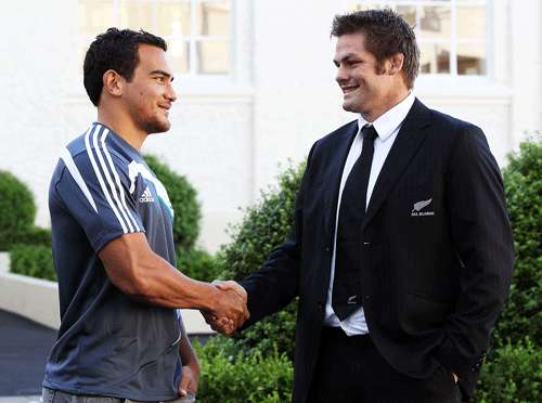 New All Blacks player Benson Stanley is congratulated by captain Richie McCaw