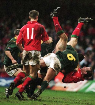 Gareth Thomas is smashed to the ground by South Africa's Corne Krige, Wales v South Africa, Millennium Stadium, Cardiff, Wales, November 26, 2000