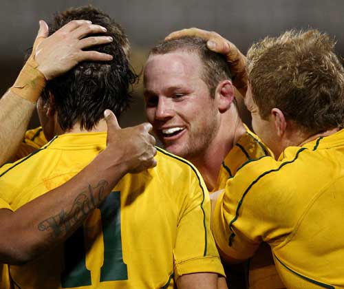 Australia No.8 Richard Brown is congratulated after scoring